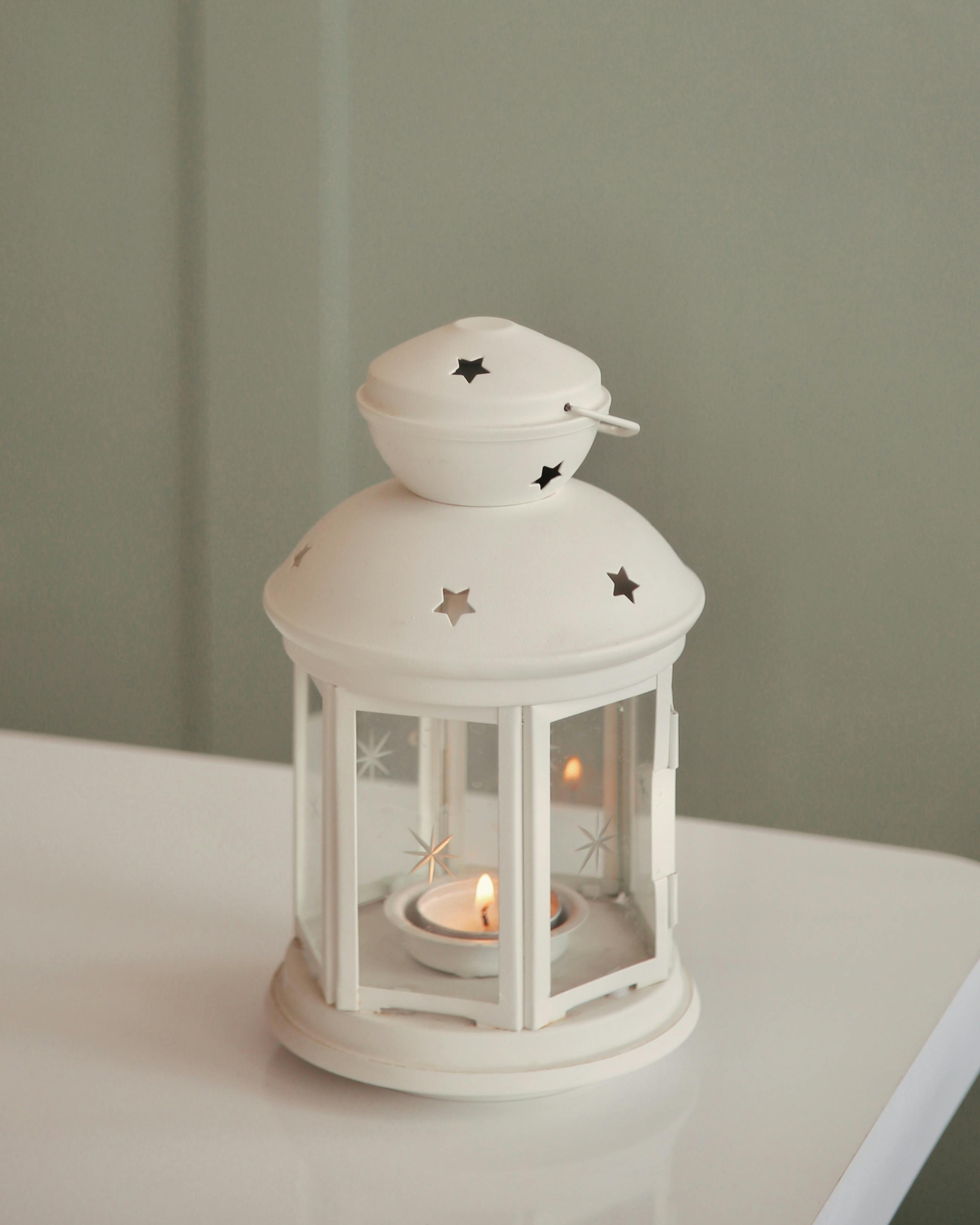 Decorative White Lantern with Lit Candle